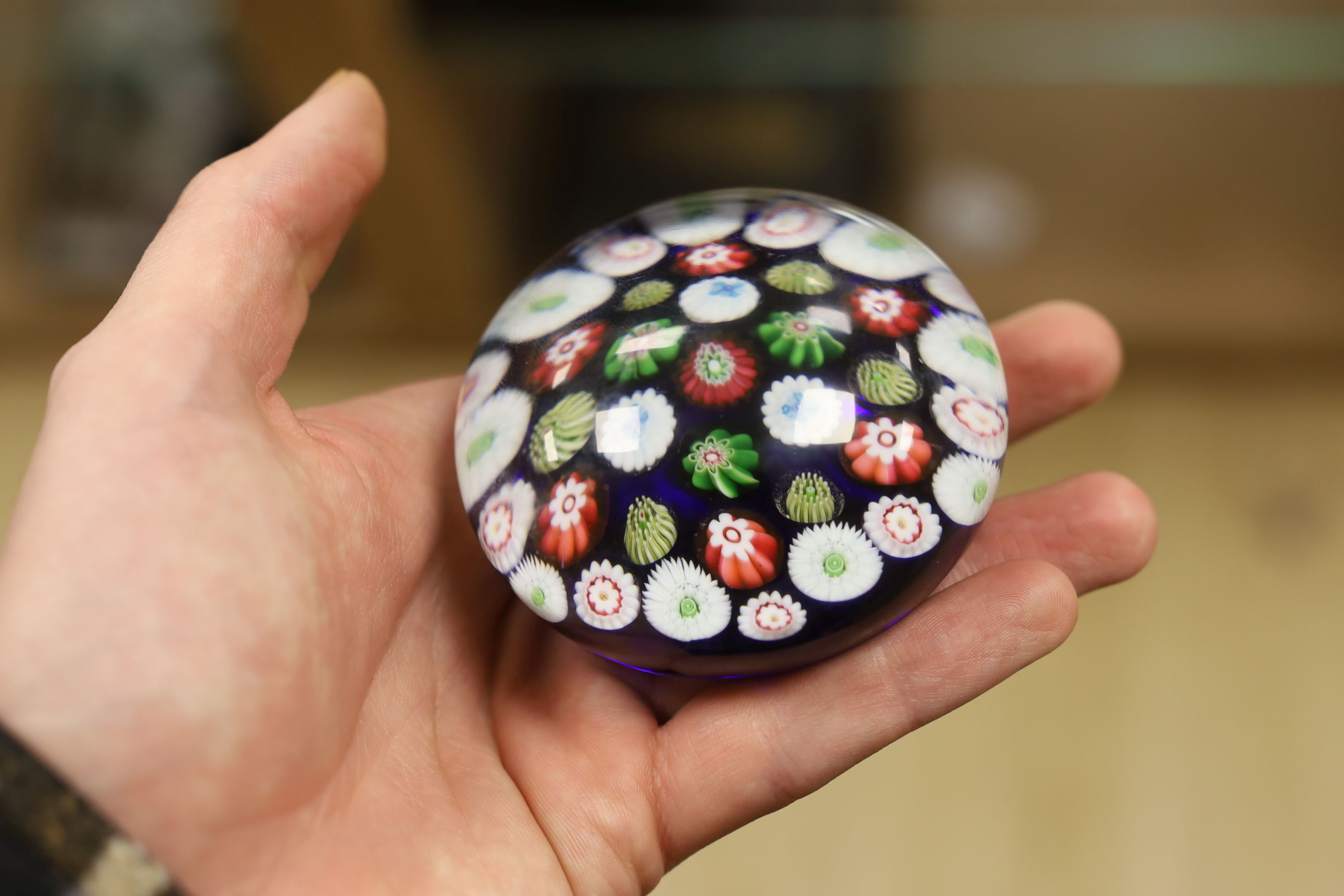 A Clichy translucent blue ground millefiori glass paperweight, 7cm in diameter